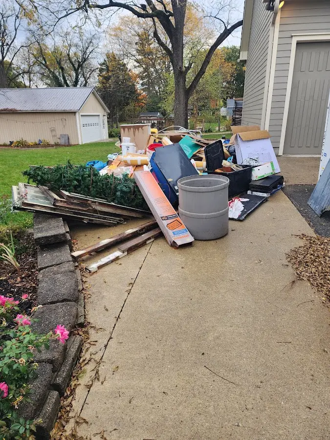 Dumpster being loaded with debris for Roofing Dumpster Rental in Grayson Valley